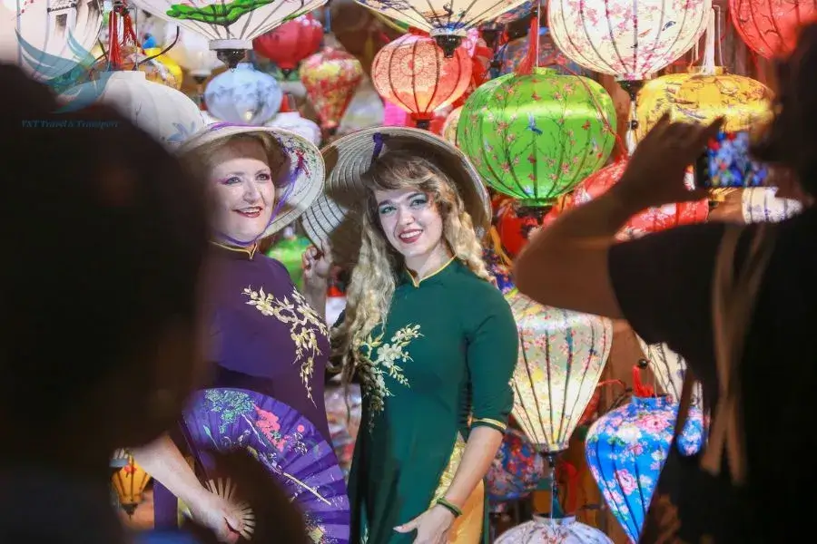 International tourists wearing Ao dai while taking photos at the event